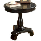 Petite table d'appoint ronde en bois avec pieds sculptés